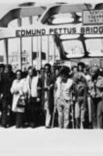 John R. Lewis and Coretta Scott-King walk across Edmund Pettis Bridge on the ten-year anniversary of Selma's Bloody Sunday.