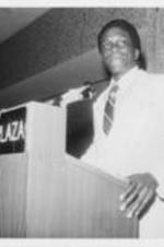 Johnny Ford is shown speaking during the 23rd Annual Southern Christian Leadership Conference Convention in Cleveland, Ohio. Caption from the September-October 1980 SCLC Magazine, page 22: The Honorable Johnny Ford, Mayor, Tuskegee, Alabama served as master of ceremonies during the convention banquet. See http://hdl.handle.net/20.500.12322/auc.199:07014.