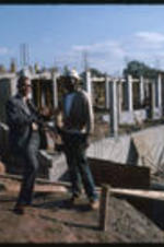 Unidentified construction worker and Dr. Vivian Wilson Henderson, president of Clark College, at the construction site of the Clark College Health and Physical Education building.
