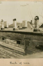 View of housetops outside a window. Written on recto: Back of Same.