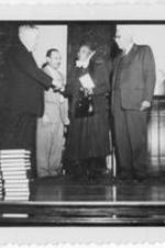 Anna E. Hall greeted by three men. Written on verso: 1954 Dedication of Anna E. Hall Dorm Gammon Theol. Seminary; Left to Right: 1. Bishop Moore 2. Dr. Harry Richardson 3. Miss Anna E. Hall 4. Bishop Bowen.