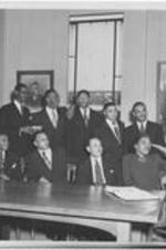 Dr. Harry V. Richardson (seated second from right) gathers with group as they listen to a speaker. Written on verso: The Student Christian League has always had a senior for president. This year the president is Joseph W. Washington of the West Texas Conference fourth from left standing.