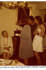 View of Velma Clark and Dr. Boll's mother at a graduation party. Written on recto: Velma Clark (in white skirt) and Dr Boll's Mother (seated).
