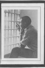 Ralph D. Abernathy is shown staring out the bars of a jail cell.
