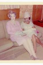 Jeanne L. Chandler and unidentified woman sitting on a sofa. Written on verso: Jeanne L. Chandler 1964, Mickey &amp; Ann.
