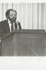 Reverend Fred Taylor testifies at a special congressional briefing at the Justice Department. The hearing was part of a series of events organized by the National Anti-Klan Network, an organization founded by the Southern Christian Leadership Conference. Written on verso: Rev. Fred D. Taylor, national director of chapters and affiliates for SCLC and a member of the National Anti-Klan Network, tells of the beating he received from a Georgia sheriff when he led a movement for justice for blacks in Wrightsville, Georgia in 1980.