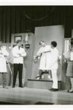 View of actors on stage. 5th person from the left is Edward Billups (Morehouse). Written on verso: See the Man Die, 1969.
