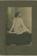 Laura Brown sits looking over her shoulder. Written on verso: Jan. 7, 191[illegible] Mrs. Laura Brown 4682 Jackwanna St., Frankford, Phila., Pa.
