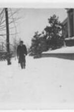 William Stanley Braithwaite walks in the snow. Written on verso: Dr. William Stanley Braithwaite - Professor of English