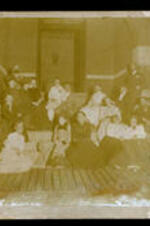 An unidentified group of men, women, and children.