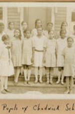 A group of young girls stand on the stoop of the Chadwick School. Written on recto: Pupils of Chadwick School