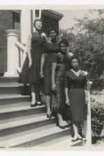 Four women standing on steps. Written on verso: "L to R Home Economics Students 1. (blank) 2. Mary Ann; fr Cedar Town, 3. (blank), 4. (blank)".