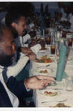 James Sanders, Portia Vavett, and Barbara [Arrington] eating at a an [Internal] Campaign. Written on verso: 1988 Internal Campaign James Sanders, Portia Vavett, Barbara [Arrington].
