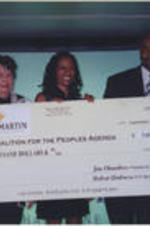 Evelyn and Joseph Lowery (second and fifth from left, respectively) pose for a photo with Remy Martin representatives while holding a check made out to the Georgia Coalition for the Peoples' Agenda.