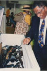 Southern Christian Leadership Conference (SCLC) President Joseph E. Lowery is shown looking into a casket filled with guns during an event for SCLC's Gun Buy-Back program.