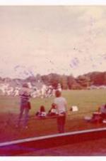 Football game. Written on verso: Beth Angela enjoyed the Cheer leader's tumbling with no concern of racial difference. Football scene- Phillip's.