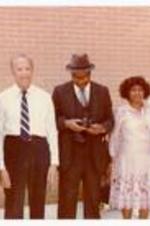 President Hugh Gloster with unidentified persons.