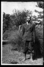 Lemoine DeLeaver Pierce's maternal grandfather, Luther White, stands outside wearing a suit.