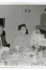 View of two men and one woman seated at table "40."